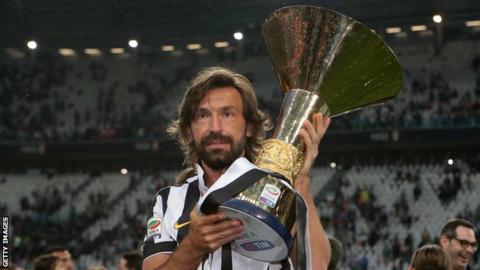 Andrea Pirlo holds up the Serie A trophy while a player for Juventus