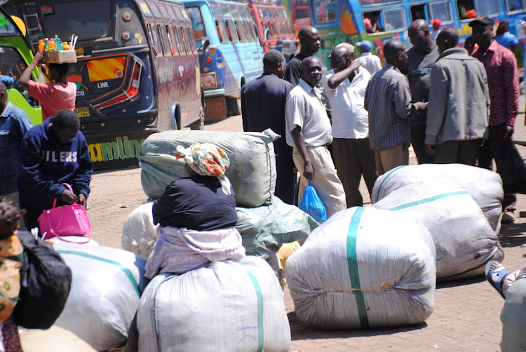Passengers collect parcels at a bus park in Nairobi.