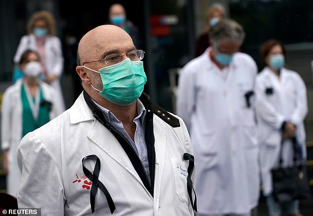 The hormone Androgen, which causes hair loss in men, has been linked to some of the worst cases of Covid-19 in Spanish hospitals. Pictured, staff from La Paz hospital in Madrid held a two-minute silence on May 14 for health workers who have died from coronavirus