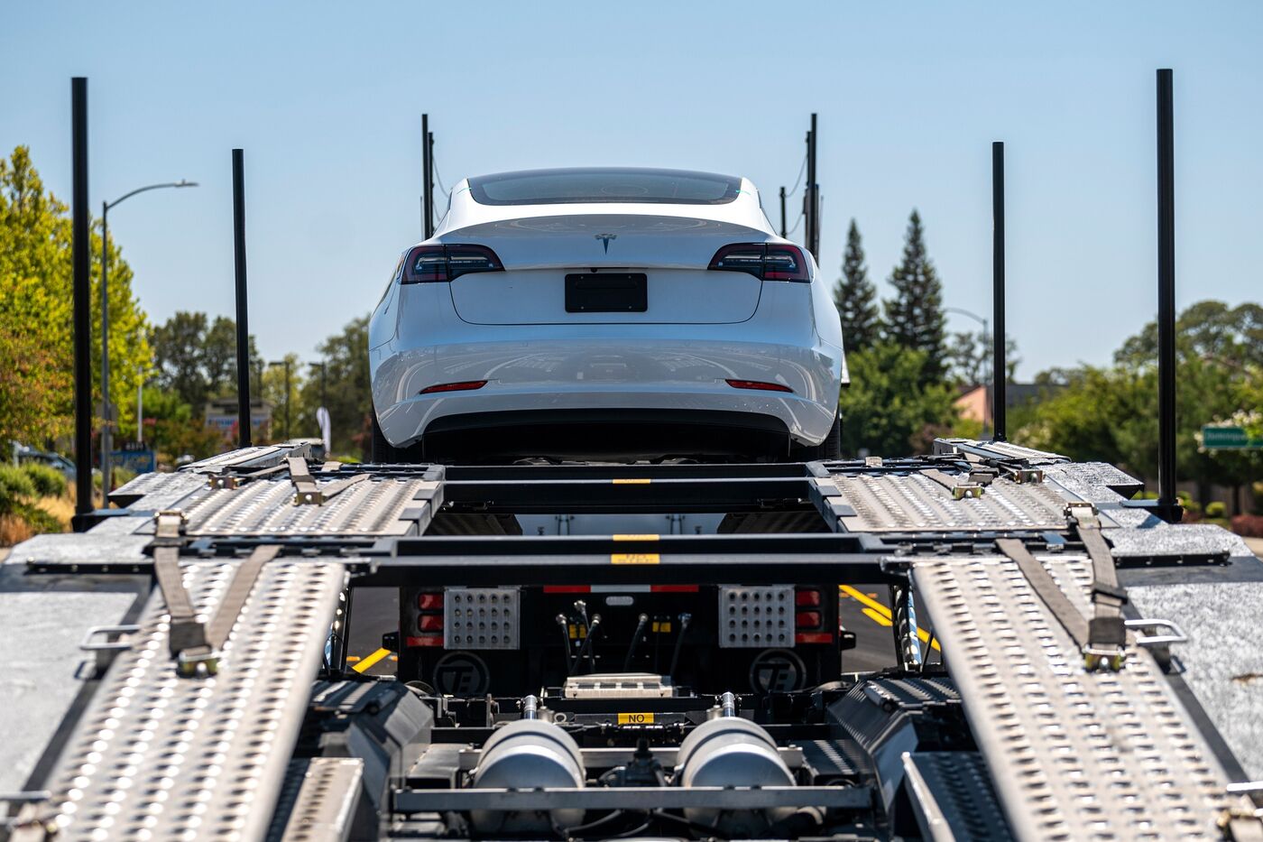 A Tesla Model 3 vehicle on an auto carrier.