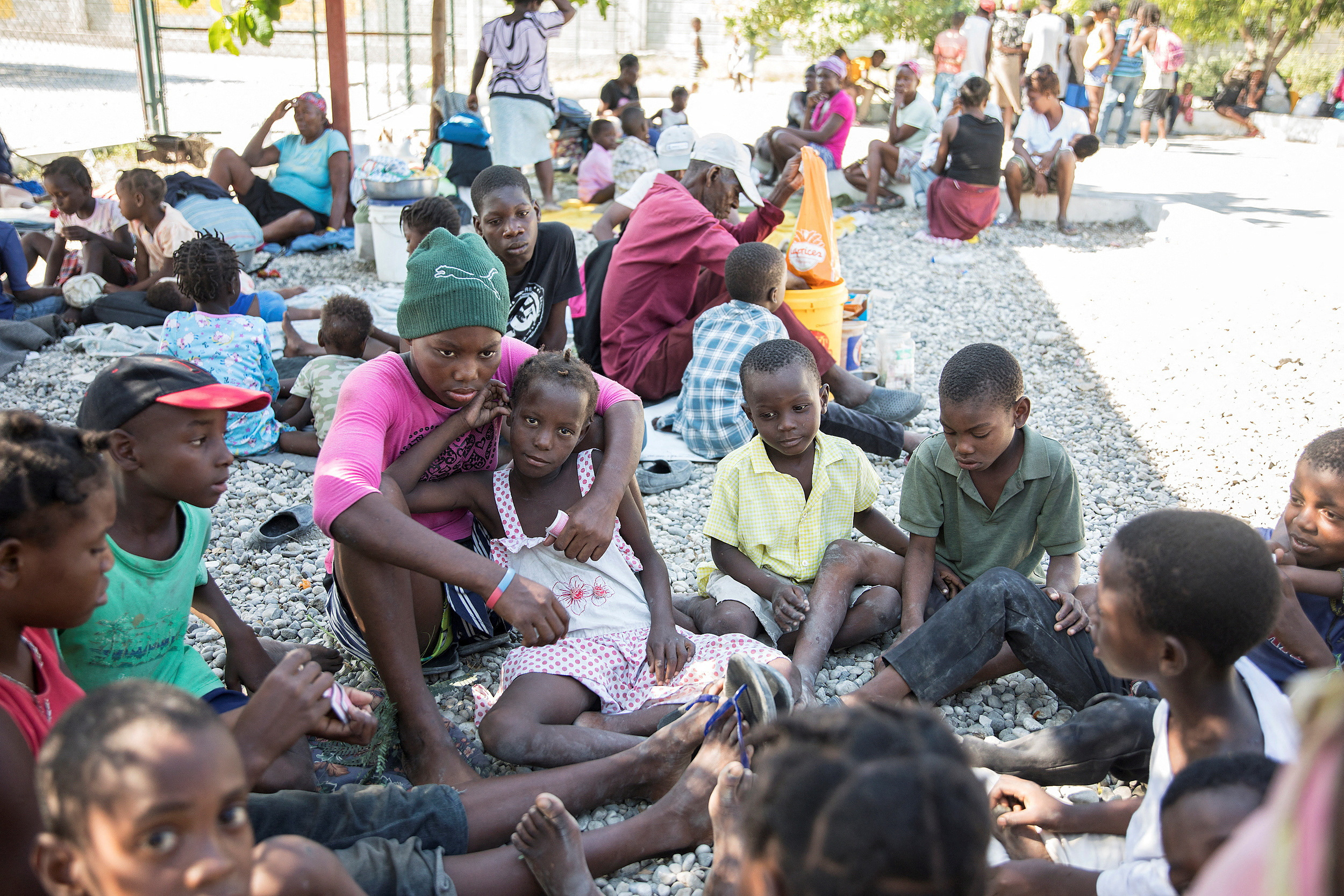 People fleeing from violence after the murder of a local gang leader camp out in the courtyard of Cite Soleil's town hall, in Port-au-Prince