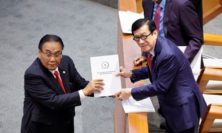 Yasonna Laoly, the Indonesian minister of law and human rights, receives the new criminal code report from Bambang Wuryanto, the head of the parliamentary commission overseeing the revision