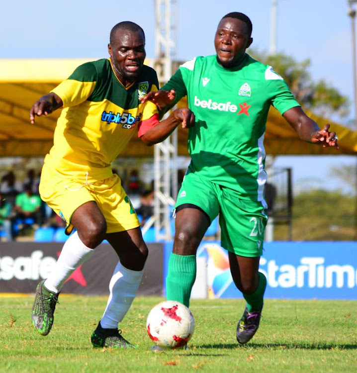 Mathare's Chrispin Ochieng (L) challenges Ernest Wendo of Gor Mahia during their Premier League match at Kasarani.