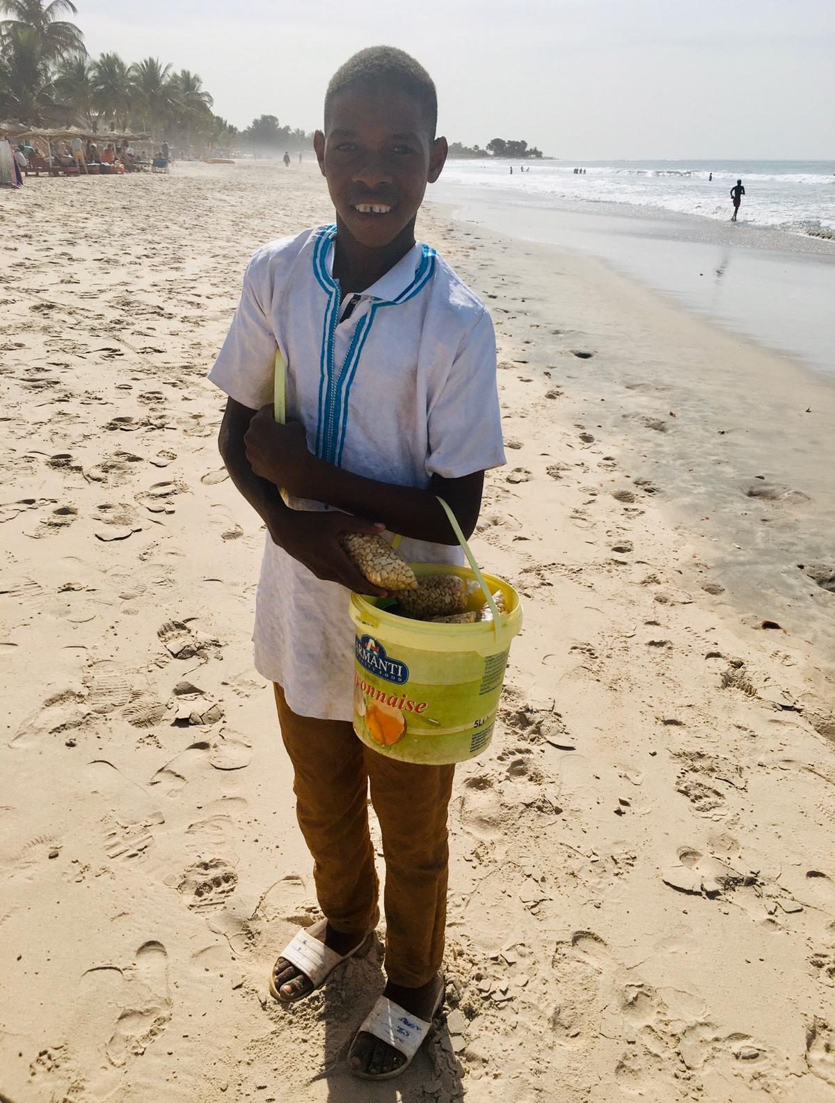  A child smiles on the beach in The Gambia, where thousands of Brits flock every year. There's no suggestion he is caught up in the child sex tourism trade